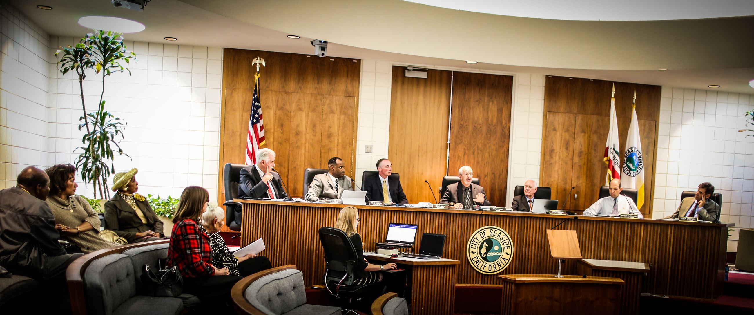 Members of the City Council seated at dias